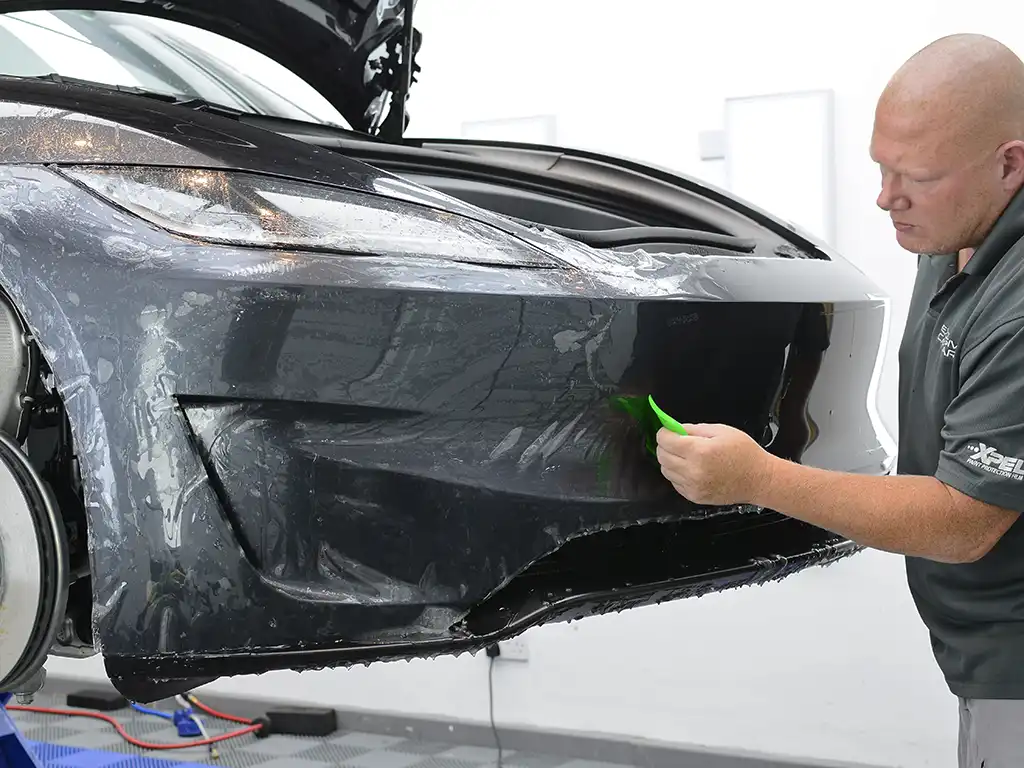 Xpel PPF being installed on a Tesla Model 3